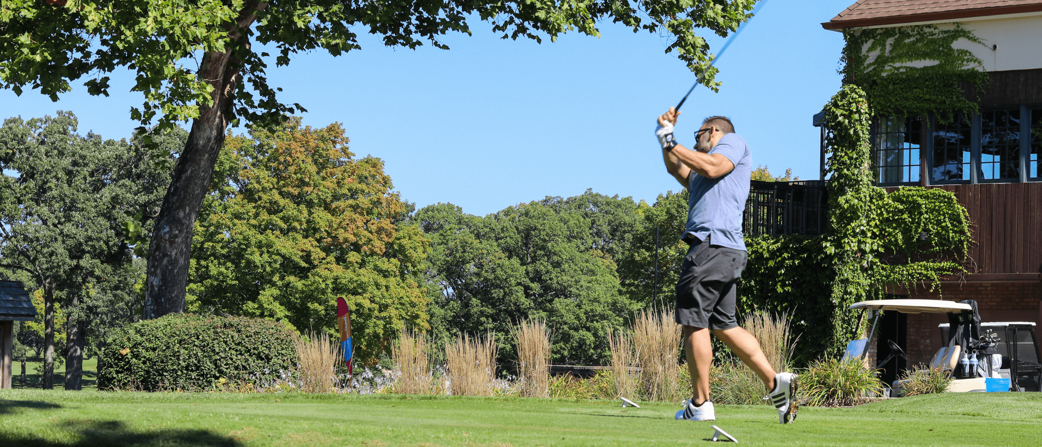 A golfer swinging his golf club at One Hope United's Charity Golf Outing.