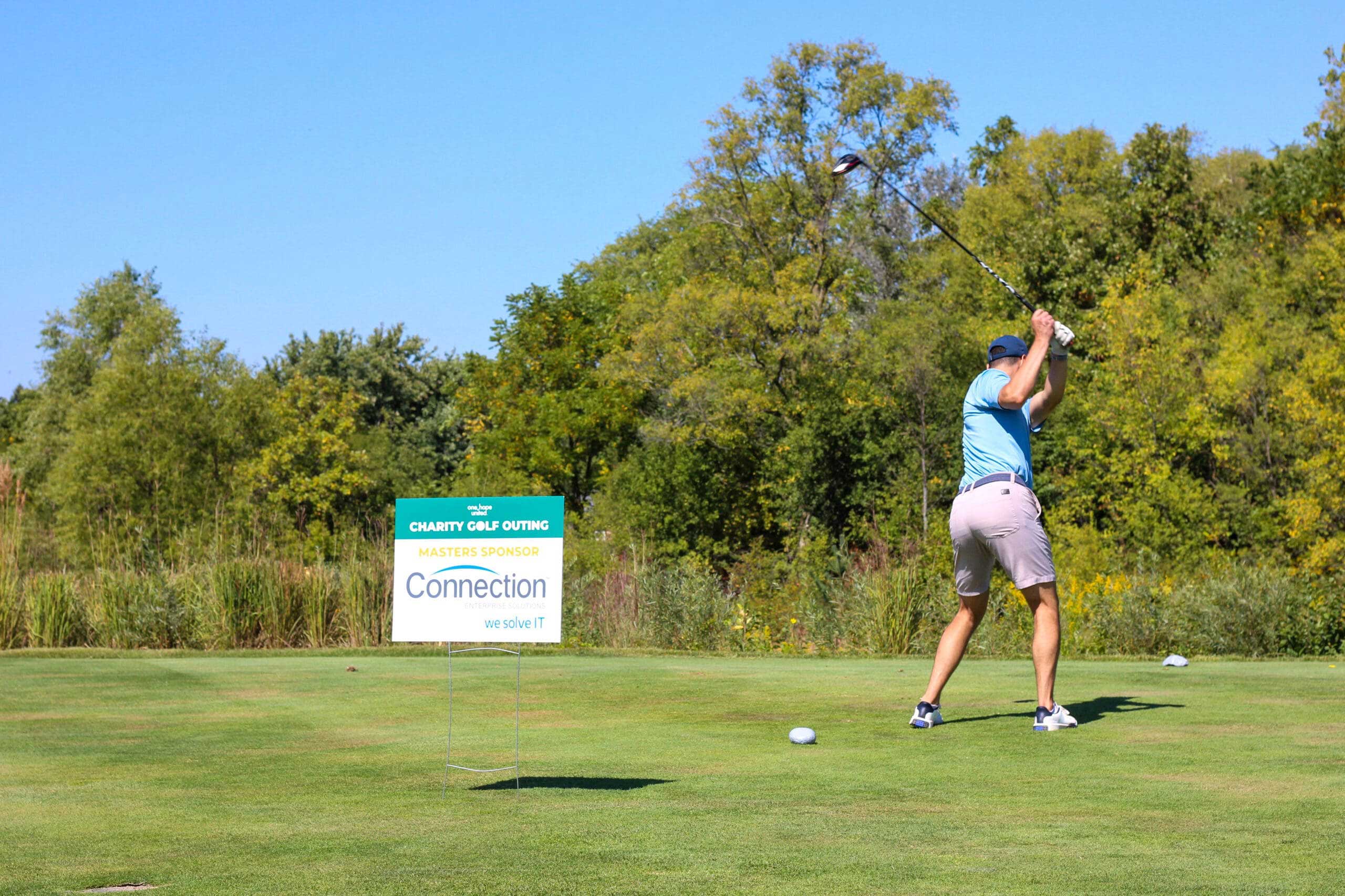 A golfer swings his club at One Hope United's Charity Golf Outing.