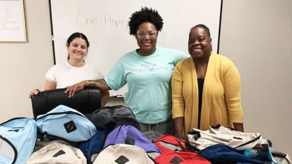 Three girls smiling at School Supplies Drive